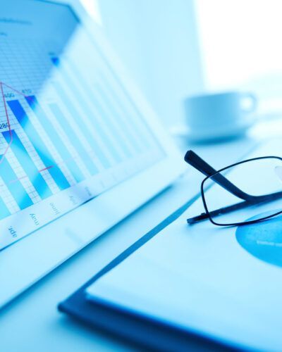Image of workplace with paper and electronic documents and eyeglasses